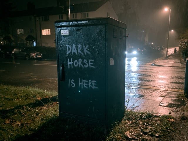 https://s.mj.run/G547b0T6aCs a black metal street box in the rain at night in the dark, UK fibre broadband cabinet. a spray paint on the cabinet says 